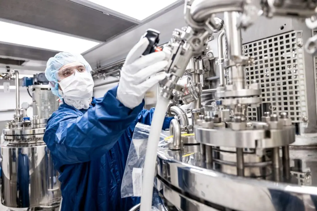 Kindeva technician operating pharmaceutical manufacturing equipment - building impactful careers in science and innovation